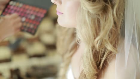 bride doing makeup in the morning. beautiful and young bride doing makeup in the morning
