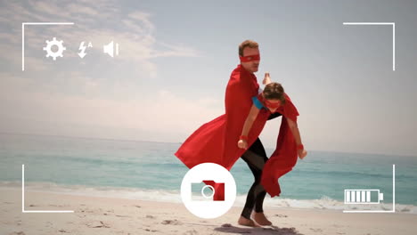 tomando fotos de padre e hija junto al mar con una cámara digital