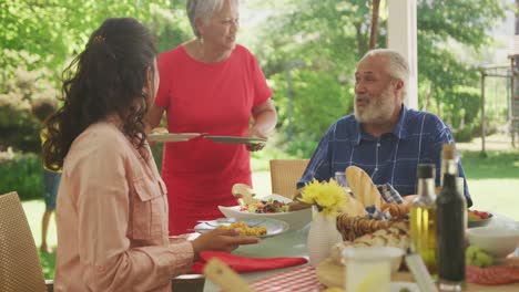 multi-generation african american family spending time in garden together