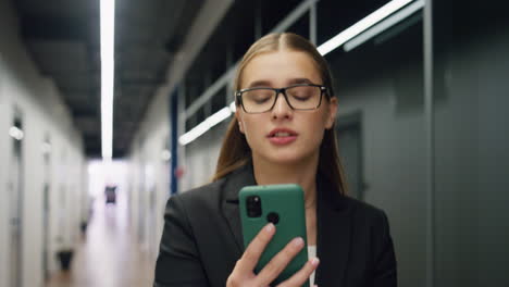 Smiling-businesswoman-talking-video-call-closeup.-Happy-freelancer-going-office