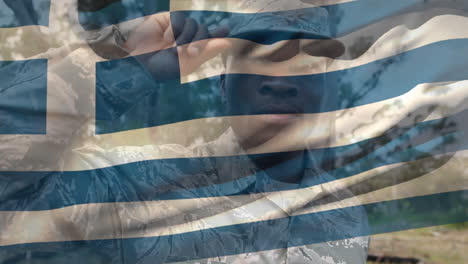 animation of flag of greece over african american male soldier