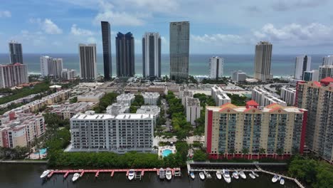aerial view of a coastal city with skyscrapers, residential buildings, and a marina