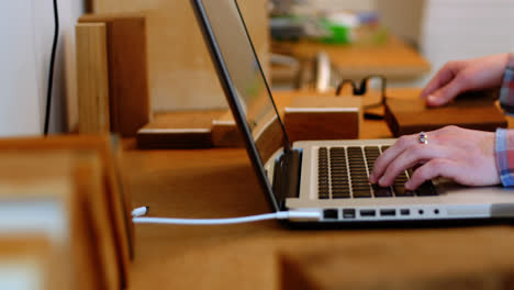 Female-executive-working-over-laptop-at-her-desk