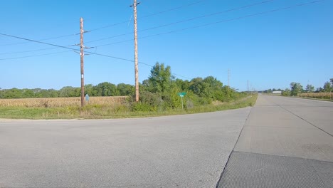 pov driving on a paved country road thru rural iowa on a sunny day