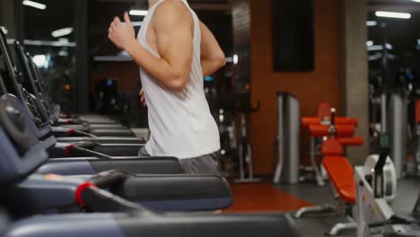 man running on treadmill in gym