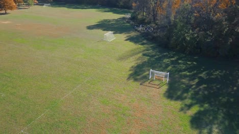 soccer goals on a grassy field in the subrubs of a park in the midwest during the autumn and fall season