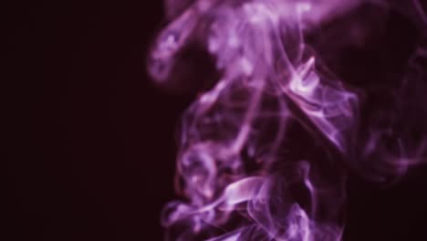Video-of-purple-clouds-of-smoke-moving-with-copy-space-on-black-background