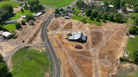 Overhead-drone-shot-of-a-farmhouse-surrounded-by-burnt-land-in-Benton-City