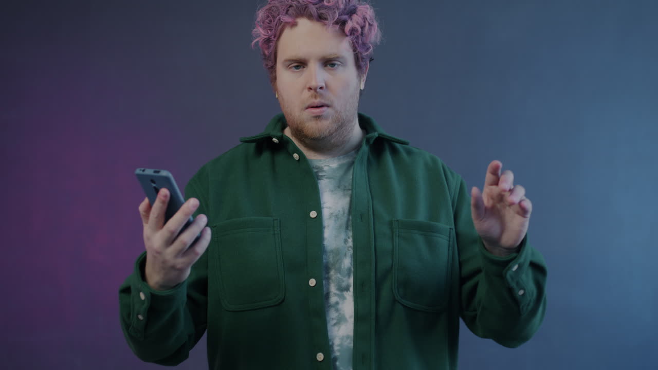 Man with Pink Hair Using Smartphone