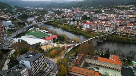 drone shot of the ourense roman and millenium bridge crossing miño river, ourense galicia spain