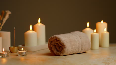 Still-Life-Of-Lit-Candles-With-Dried-Grasses-Incense-Stick-And-Soft-Towels-As-Part-Of-Relaxing-Spa-Day-Decor-3
