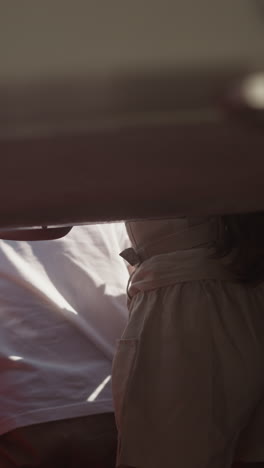 little children stand leaning out of motorboat hatch in salon on sea trip. curious brother and sister ride yacht together on summer vacation. family time