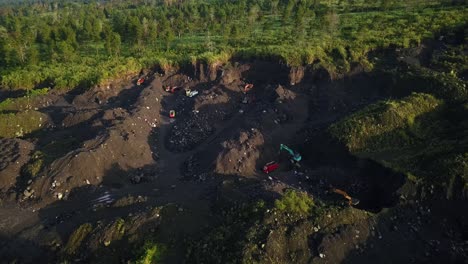 aerial top down shot of working illegal on sand mine and destroying forest woodland in asia