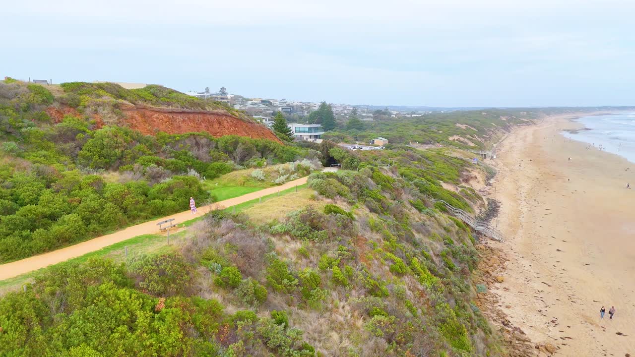 Aerial view of beach, hills, and town