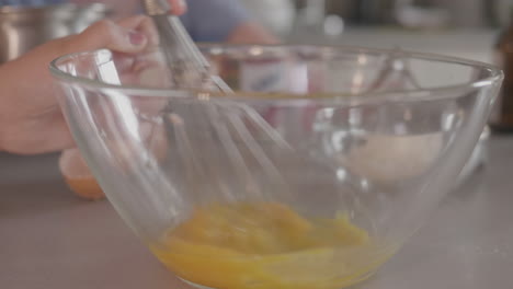 whisking-eggs-in-a-clear-mixing-bowl