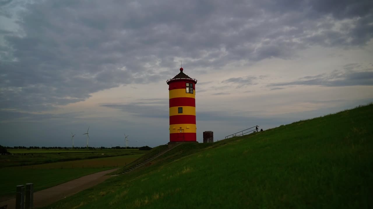 Red yellow little krichtum on a green dune by the sea in the north of Germany in the evening of Ottowalk