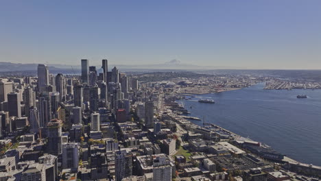 seattle washington aerial v145 flyover belltown capturing downtown cityscape, ferries crossing the waters and mountain backdrop under cloudless blue sky - shot with mavic 3 pro cine - oct 6th 2023