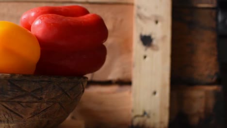 vibrant bell peppers and mushrooms in rustic wooden bowl