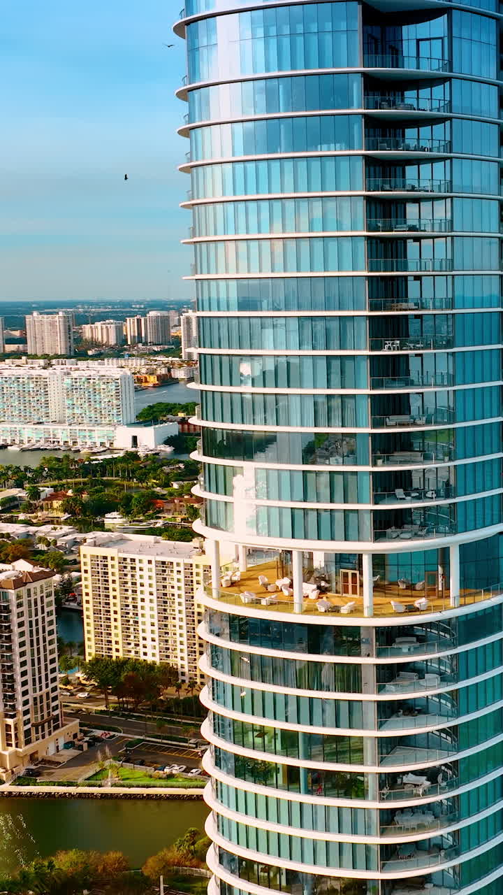 Row of gorgeous skyscrapers on the shore of Miami Beach. Amazing scenery of the city from top. Vertical video