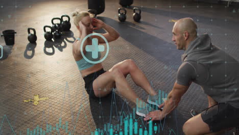 fitness data tracking animation over woman doing sit-ups with trainer in gym