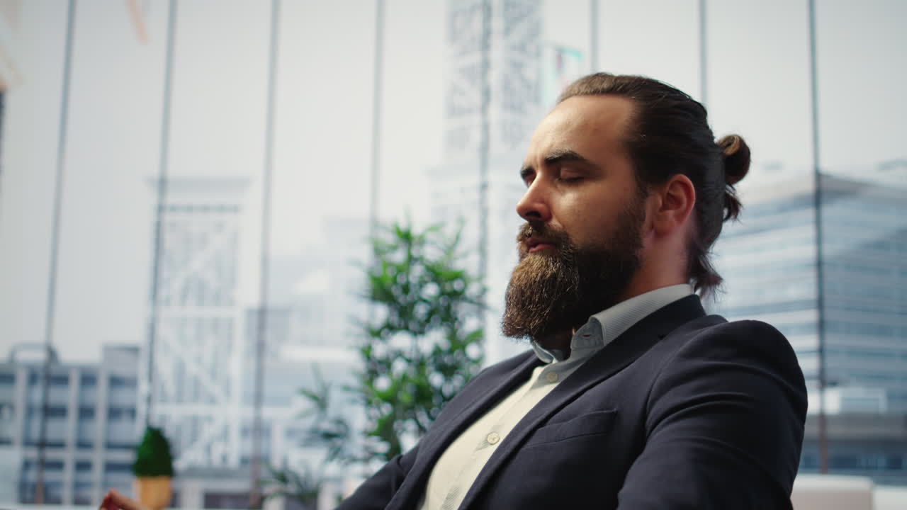 Vertical Video CEO leans back in his office chair engaging in a guided meditation session