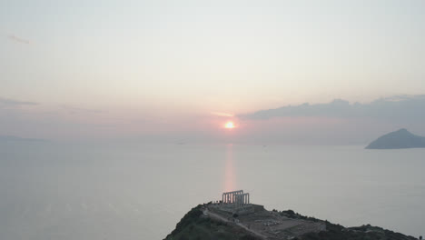 Drone-shot-of-ancient-ruins-in-Greece-with-sun-setting-in-background