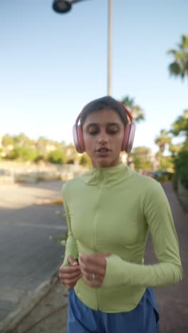 woman running outdoors with headphones