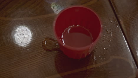 red plastic cup on a wooden table