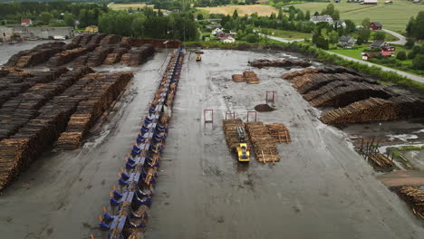 Wheel-Loader-Working-And-Stacking-Lumber-At-Industrial-Area-In-Braskereidfoss,-Norway