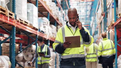 warehouse workers checking inventory and talking on the phone