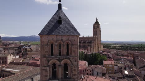 aerial view of church tower of san esteban with view of segovia cathedral in background on sunny day