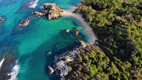 Aerial-view-of-turquoise-ocean,-beaches-and-the-coast-of-Tayrona,-Colombia---rising,-drone-shot