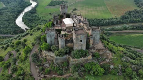 majestic aerial view of almodovar castle with guadalquivir river behind