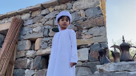 arab kid in arabian traditional house made with stone