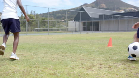 playing soccer, child kicking ball on school field, enjoying outdoor activity