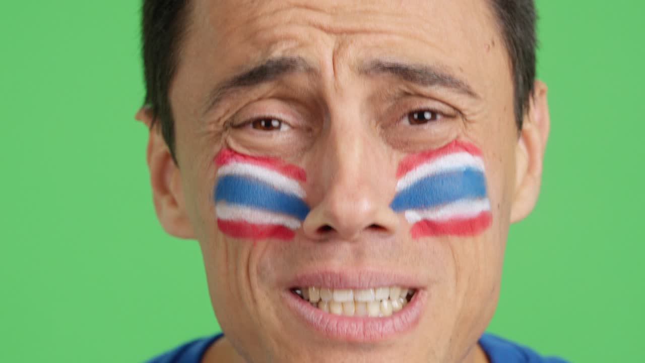Very nervous man supporting thai team during a difficult match