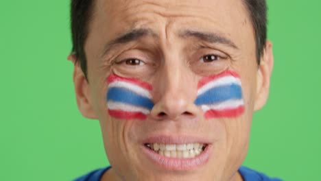 very nervous man supporting thai team during a difficult match