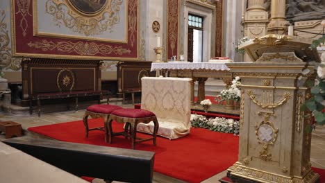 red carpeted wedding altar with floral decor inside bom jesus church in braga portugal