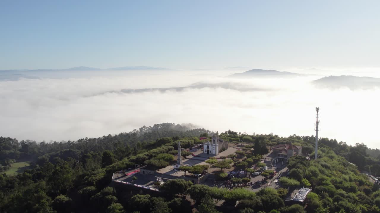 Monte Franqueira, Barcelos, emerges through morning fog, surrounded by lush greenery and hills