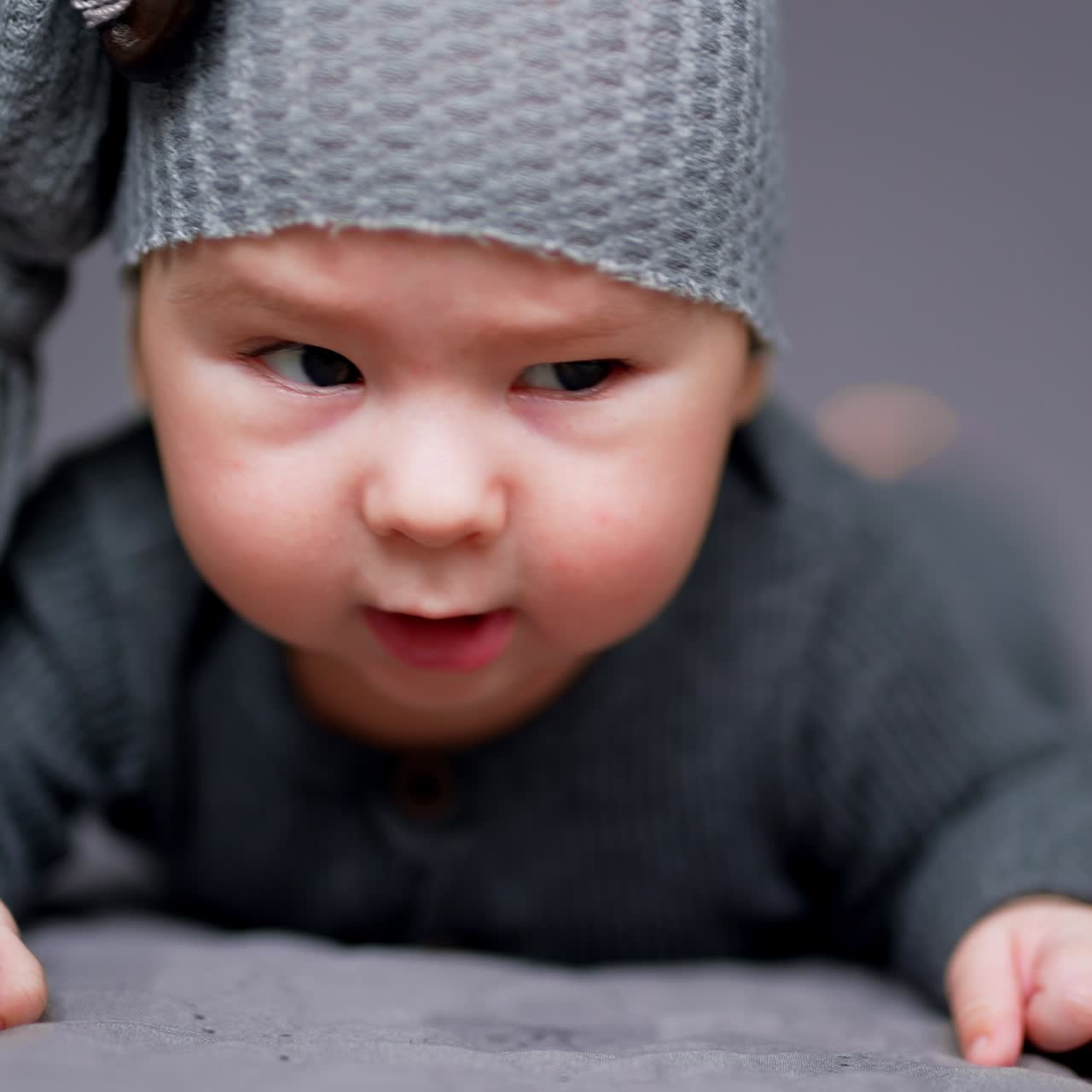 Nice little newborn kid portrait. Small funny baby lying on the bed