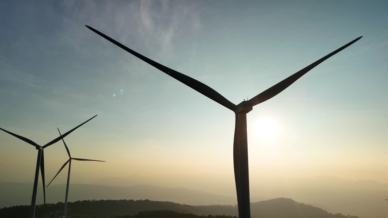 Wind power hill with rotating blades in the brilliant morning sunlight in Da Lat - Vietnam