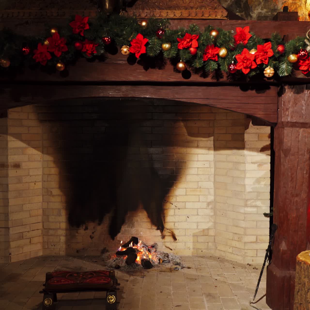 Festive cozy fireplace. New Year's design background near the fireplace. Christmas decorations inside the room with pleasant mantel. Warm home mood.