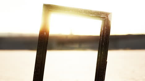 empty wooden picture frame on the beach sand