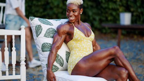 smiling bodybuilder woman in a yellow swimsuit