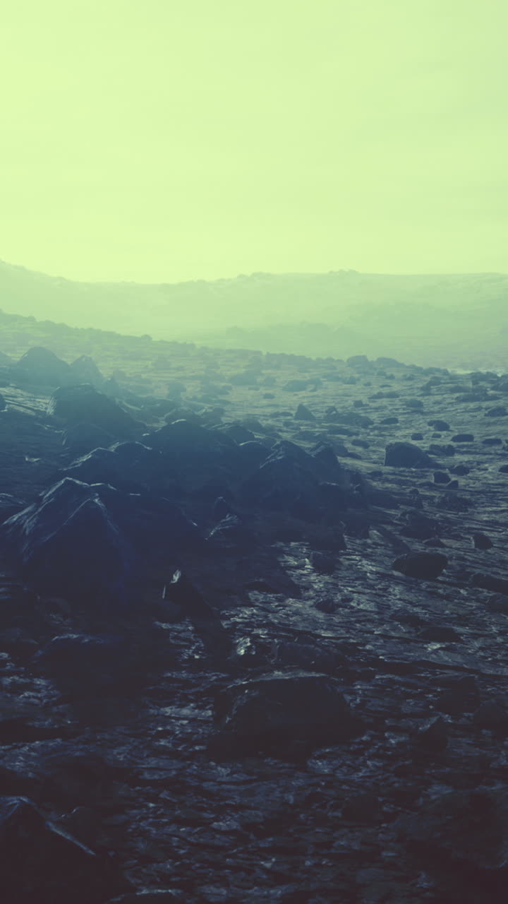 Vast rocky landscape under a soft greenish glow at dawn or dusk