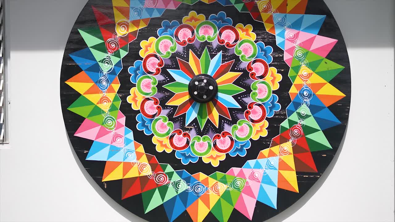 Colorful Painted Wheel: Vibrant Mandala Folk Art
