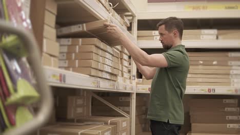 worker arranging boxes on shelves in a warehouse