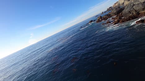 A-fast,-banking-low-flying-perspective-over-the-rocky-coastline-of-Catalina-Island