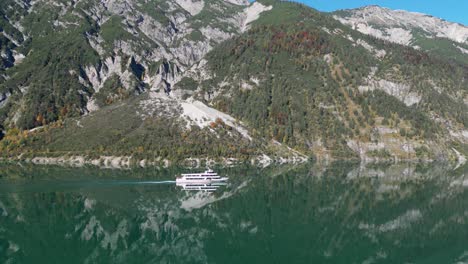 boat sails at mountain lake achensee in tyrol, austria - aerial 4k