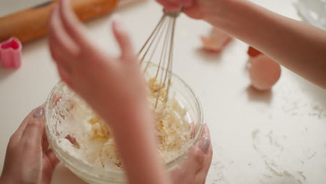 child helping bake cookies
